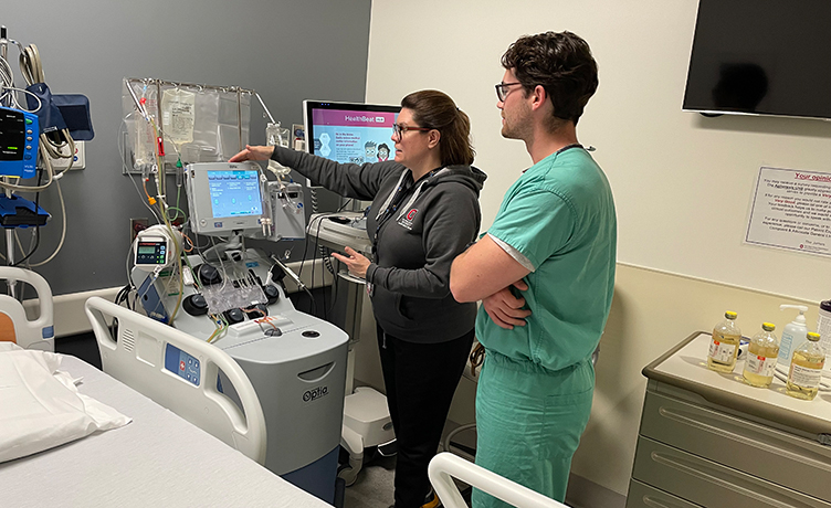 A third year medical student learns about machine technology in Blood Transfusion.