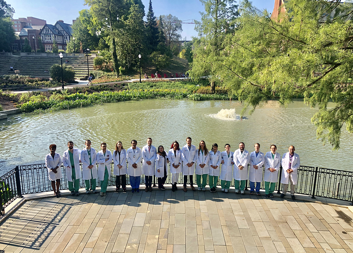OSU pathology residents stand near Mirror Lake on the OSU campus